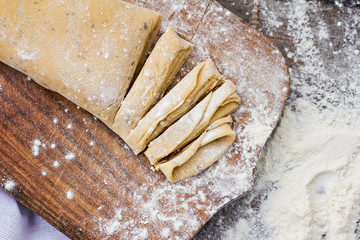 Homemade spaghetti, pasta or noodles on wooden table. 