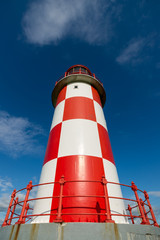 Looking up at Tall Red and White Lighthouse