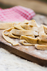 Homemade spaghetti, pasta or noodles on wooden table. 