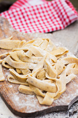 Homemade spaghetti, pasta or noodles on wooden table. 
