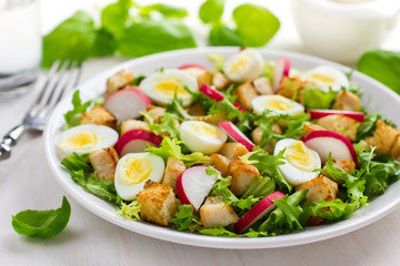 Salad with chicken, croutons, radish and quail eggs