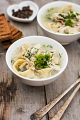 A bowl of soup with noodles and chicken 