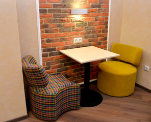 Upholstered modular furniture and little table in office room