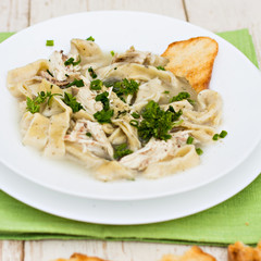 A bowl of soup with noodles and chicken 