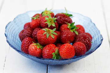 fresh strawberries over white wood