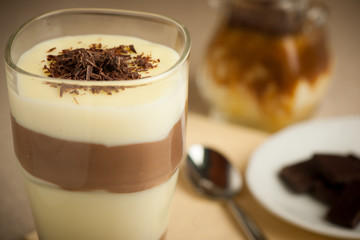Mixed chocolate and vanilla pudding served in a glass decorated