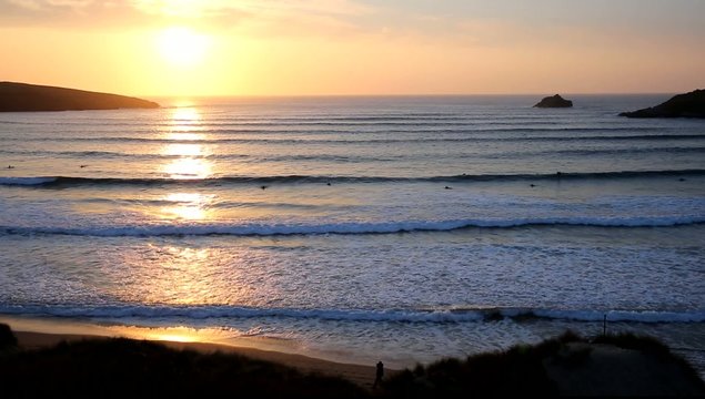 Sunset in Cornwall surfers surfing Crantock 
