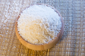 a bowl of rice on wooden surface top view