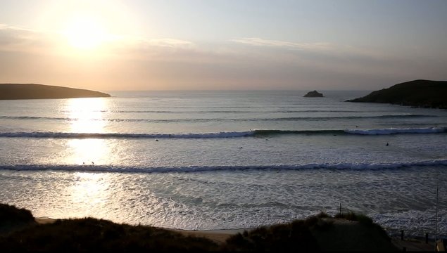 Sunset in Cornwall surfers surfing Crantock 
