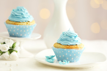 Delicious cupcakes on table on light background