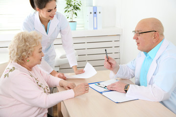 Fototapeta premium Happy doctors and patient in hospital clinic
