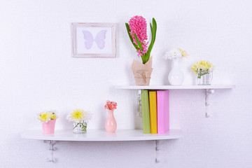 Flower on shelves on white wall background