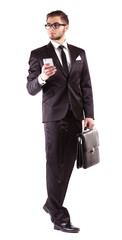 Elegant man in suit with mobile phone and briefcase isolated on white