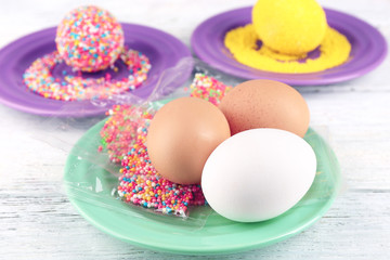 Decoration Easter eggs with colorful beads on wooden table, closeup