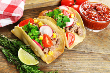 Mexican food Tacos on wooden table, closeup