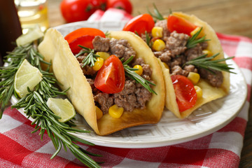 Mexican food Tacos in plate on napkin, closeup