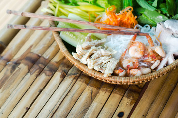 straw plate with ingredients for vietnamese spring rolls