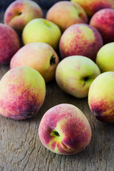 group of fresh peaches on wood background