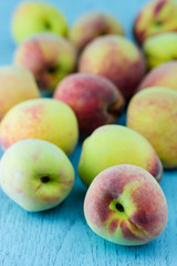group of fresh peaches on wood background