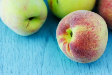 group of fresh peaches on wood background
