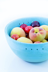 Juicy peaches and apricots in wooden bowl