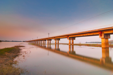 The railway bridge over the river with sunset view