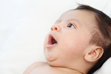The cute baby boy is sleepy relax portrait on the white bed