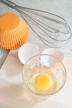 ingredients and tools to make a cake, eggs, bakery cups