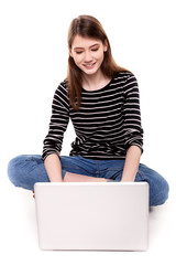 Naklejka premium Young Happy Woman with PC on Floor E-commerce Stock Image