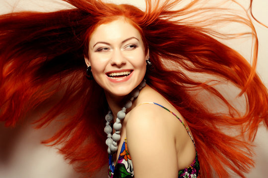  happy woman with long flowing red hair