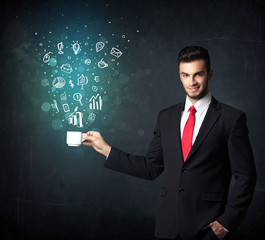 Businessman holding a white cup with business icons