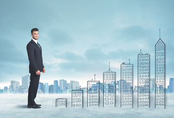 Business man climbing up on hand drawn buildings in city