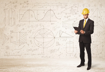 Handsome engineer calculating with hand drawn background