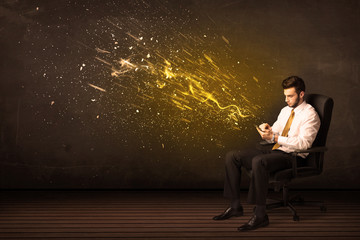 Businessman with tablet and energy explosion on background