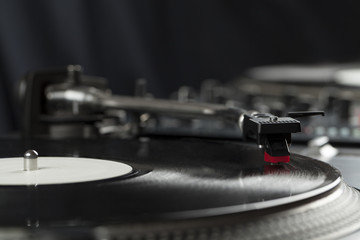 Turntable playing vinyl close up with needle on the record