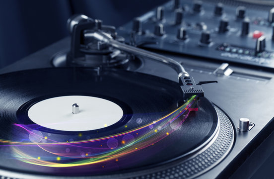 Turntable playing vinyl with glowing abstract lines