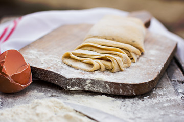 Homemade spaghetti, pasta or noodles on wooden table. 