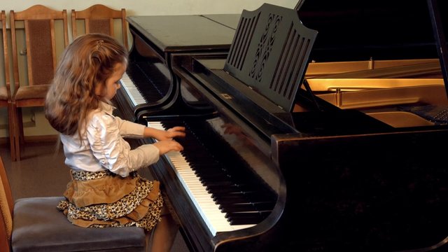 Cute little girl plaing grand piano, 4k, Dance of the Aborigines