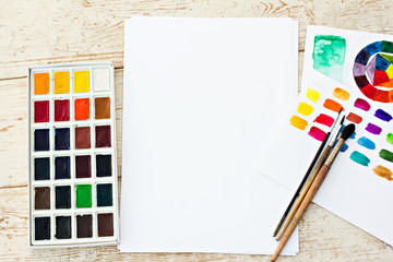 Workplace artist - paper, paint, brushes, color wheel