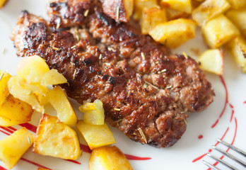 Grilled meat sausages with potatoes