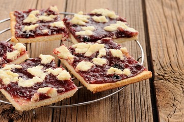 Berry jam cookies on wooden background