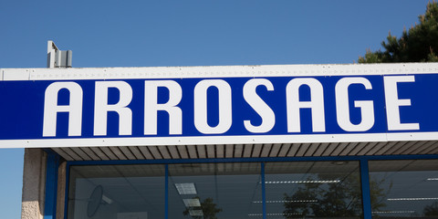 A white and blue Billboard watering store