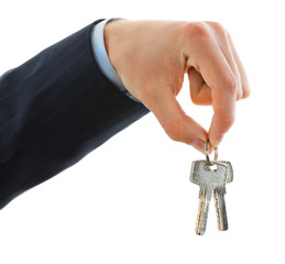 House keys in the female hand on a white background