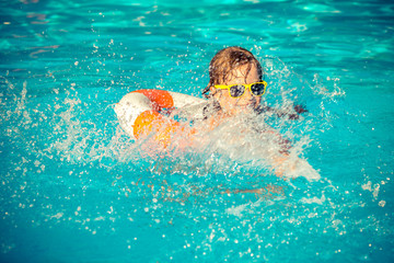Child playing in swimming pool