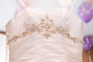 Wedding dress hanging on a shoulder