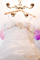 Wedding dress hanging on a shoulder