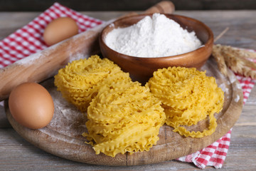 Still life of preparing pasta on rustic wooden background