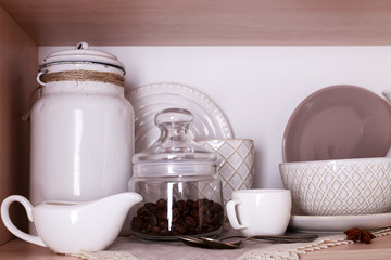 Kitchen utensils and tableware on shelf