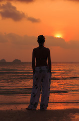 Girl on sunset background.
