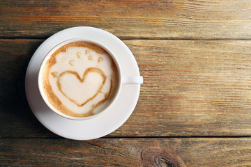 Cup of coffee latte art on wooden background